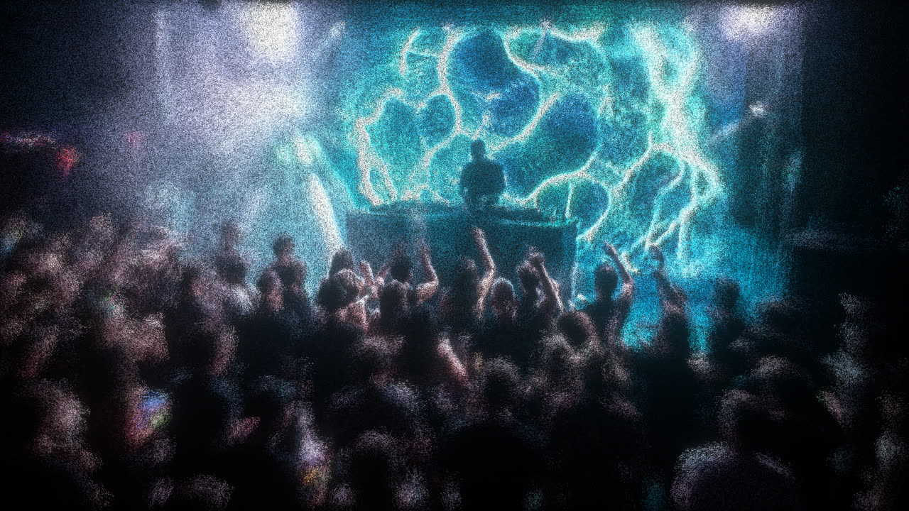 A DJ on stage in a packed room, with Curl Flow visuals on the screen behind the booth